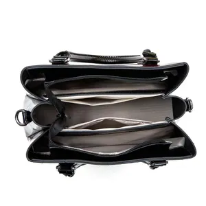 Interior view of black tote bag showing chevron lining and multiple zipper compartments