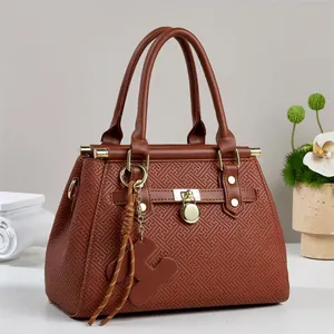 Brown embossed leather tote bag with gold padlock and decorative braided strap ornament