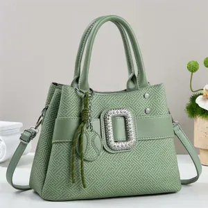 Elegant green handbag with geometric texture and sparkling rhinestone buckle details