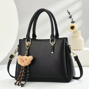 Retro black Boston handbag for women with litchi texture and cute bear pendant charm