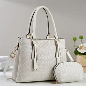 Chic beige tote bag with woven texture and matching coin purse on display