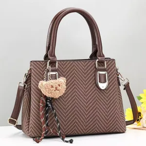 Women's brown herringbone handbag with leather handles, plush bear charm and silk scarf