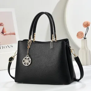 Retro black leather satchel with litchi grain texture and gold hardware details