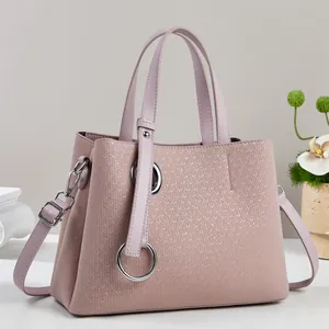 Pink woven texture tote bag with silver rings and adjustable shoulder strap