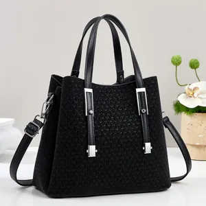 Elegant black woven tote bag with leather handles and silver hardware for women