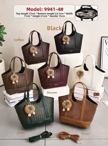 Detail view of woven leather tote bags in seven colors with matching fur ball charms