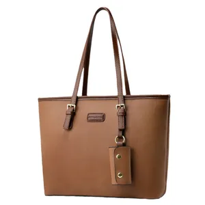 Classic brown tote bag with litchi grain texture and a decorative small cylinder charm