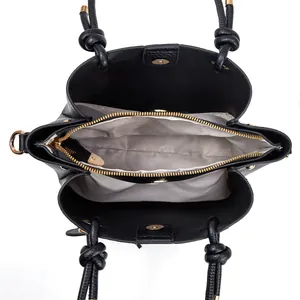 Top view of leather bucket bag interior with gray lining and three compartments