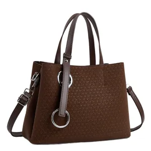 Brown tote bag with V-weave texture, top handles, and adjustable shoulder strap for women