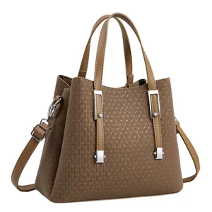Minimalist brown tote bag with V-shaped texture, dual handles and silver metal accents