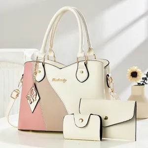 Three-piece women's handbag set in cream white with colorful patchwork and gold hardware