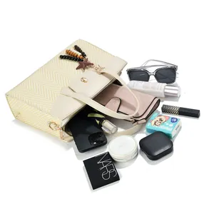 Flat lay of woven straw tote bag showing spacious interior with daily essentials