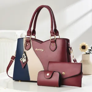 Three-piece women's handbag set featuring color-block tote, wallet, and card holder