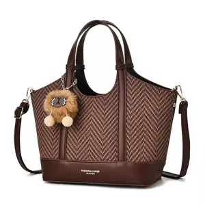 Detailed view of large capacity tote bag with herringbone pattern and soft plush charm
