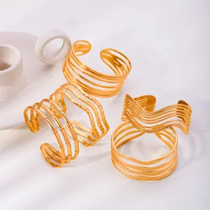 Gold plated bohemian open cuff bracelets featuring geometric bamboo and wave line designs