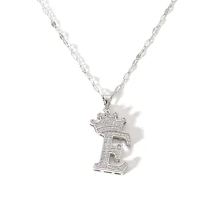 Detailed close-up shot of silver crown letter E zircon necklace pendant accessory