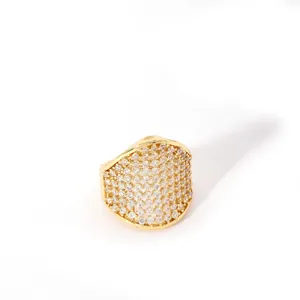 Detail of wide dome ring in gold finish featuring micro-pave white zircon stones