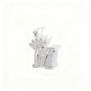 Detailed close-up view of the sparkling zircon paved letter M pendant featuring a mini crown.