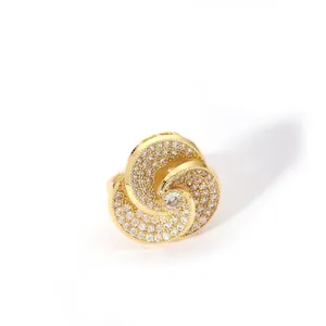 Macro detail of gold spiral ring with pavé-set zircons and round center diamond