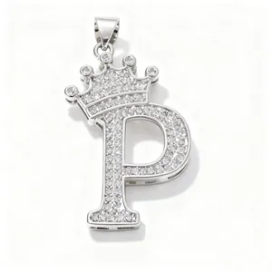 Silver tone cubic zirconia crown letter P pendant close up, shiny stone inlay jewelry detail view.