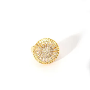 Macro detail of gold-plated cocktail ring with crystal pavé and sunburst openwork