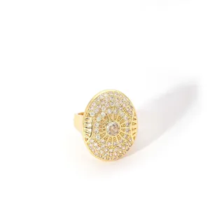 Detail of gold-plated stainless steel ring with micro-pave zircon and geometric sunburst pattern