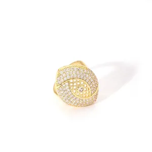 Macro detail of gold plated oval eye ring with micro-pave crystals and hollow grid pattern