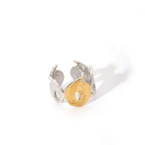 Detail of two-tone geometric open ring with leaf texture in silver and gold finish