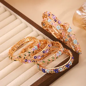 Exquisite hollow floral enamel bangles in gold with colorful cloisonné detailing