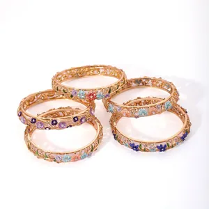 Set of five gold hollow-out cloisonne bracelets with colorful enamel floral details