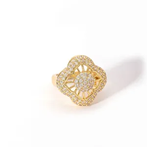 Macro shot of gold-plated geometric flower ring featuring intricate pavé-set crystals