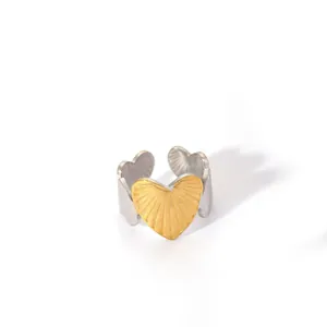 Detailed macro of two-tone heart-shaped adjustable ring with sunburst metal texture