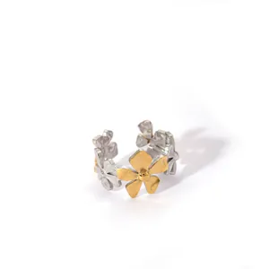 Detailed macro view of dual-tone gold and silver floral stainless steel ring