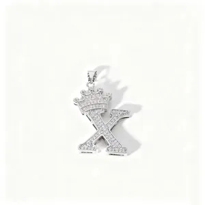 Close-up detail of silver crown letter X pendant necklace with sparkling zirconia stones.