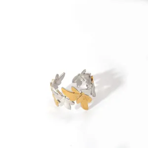 Detailed close-up of butterfly motifs on a two-tone gold and silver adjustable ring