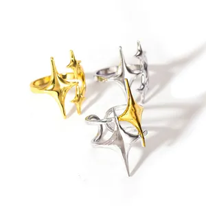 Minimalist four-pointed star rings in gold, silver, and two-tone finishes on white background