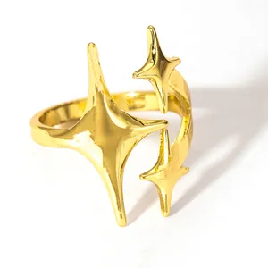 Detailed view of gold plated ring featuring three polished four-pointed star charms
