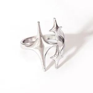 Minimalist silver star ring featuring three polished four-pointed stars on white background