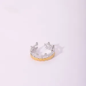 Detailed macro view of two-tone open ring featuring silver crown and golden twisted rope design