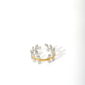 Close-up of dual-tone open ring with silver beads and golden center line detail