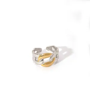 Macro detail of mixed-metal chain link ring with polished gold and silver finish