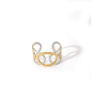 Detail view of two-tone geometric open ring with interlocking gold and silver rings