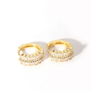 Detail of 18K gold-plated hoop earrings featuring triple rows of cubic zirconia stones