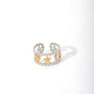 Detail shot of a mixed-metal open ring featuring star, heart, and moon beaded charms