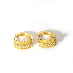 Close-up of 18K gold stainless steel hoop earrings featuring yellow square gemstones