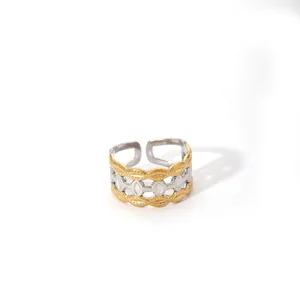 Macro detail of two-tone gold and silver chain ring with adjustable open band