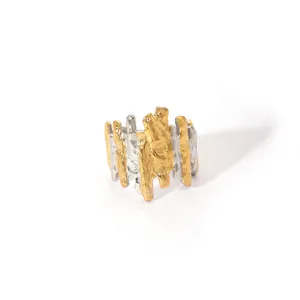 Macro detail of wide textured ring with two-tone gold and silver lava surface
