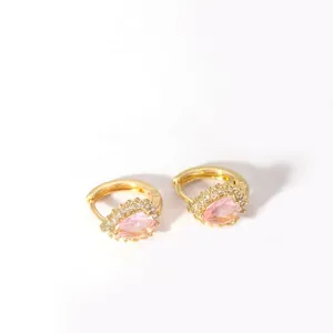 Detail of 18K gold hoop earrings with pear-shaped pink stone and halo crystal setting