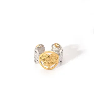 Detail of two-tone open ring featuring a hollow circle with heart and hugging hands design