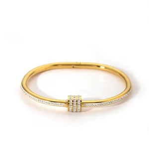 Detailed close-up of a gold-plated copper bangle featuring micro-set zircon stones